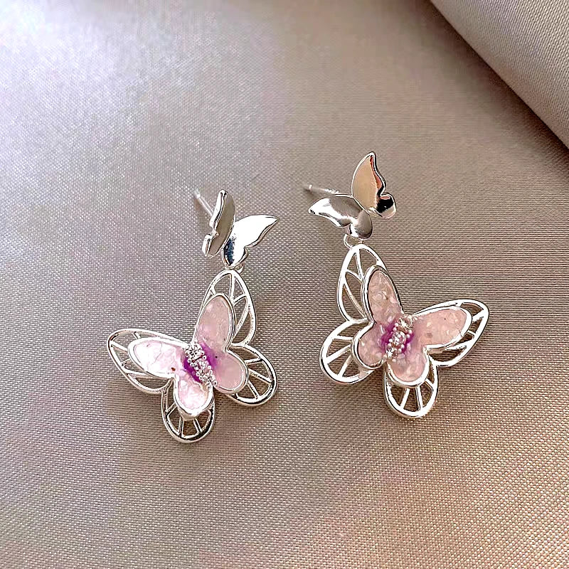 Model showcasing the dangle and style of the 14K Gold-Plated Elegant Zircon Butterfly Earrings