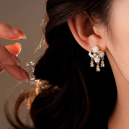 Model showcasing the dangle and style of the 14K Gold-Plated Elegant Zircon Butterfly Earrings
