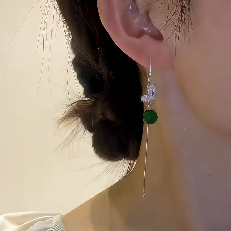 Model showcasing the dangle and style of the 14K Gold-Plated Elegant Zircon Butterfly Green Bead Threader Earrings