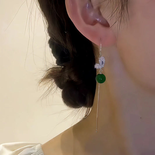 Model showcasing the dangle and style of the 14K Gold-Plated Elegant Zircon Butterfly Green Bead Threader Earrings