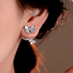 Model showcasing the dangle and style of the 14K Gold-Plated Elegant Zircon Butterfly Jacket Earrings