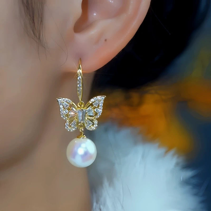 Model showcasing the dangle and style of the 14K Gold-Plated Elegant Zircon Butterfly Mabe Pearl Ear Hooks