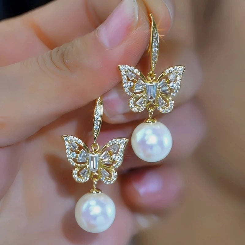 Angled view of the 14K Gold-Plated Elegant Zircon Butterfly Mabe Pearl Ear Hooks
