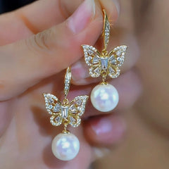 Angled view of the 14K Gold-Plated Elegant Zircon Butterfly Mabe Pearl Ear Hooks