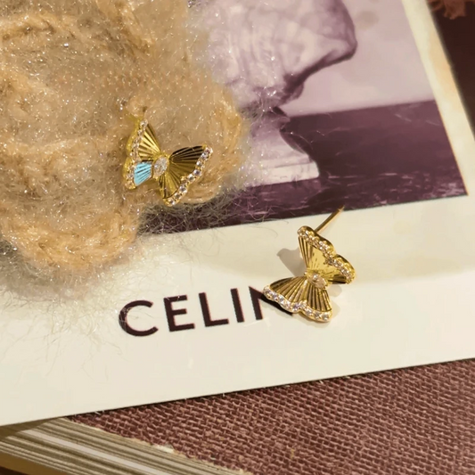 Model showcasing the dangle and style of the 14K Gold-Plated Elegant Zircon Butterfly Studs