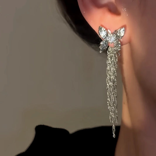 Model showcasing the dangle and style of the 14K Gold-Plated Elegant Zircon Butterfly Tassel Earrings