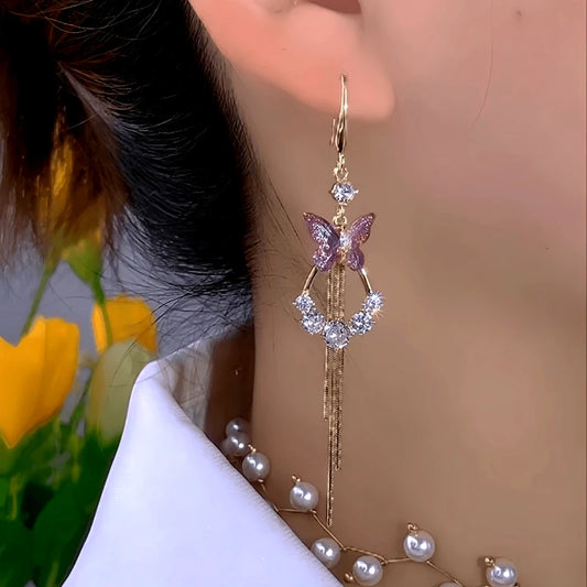 Model showcasing the dangle and style of the 14K Gold-Plated Elegant Zircon Butterfly Tassel Earrings