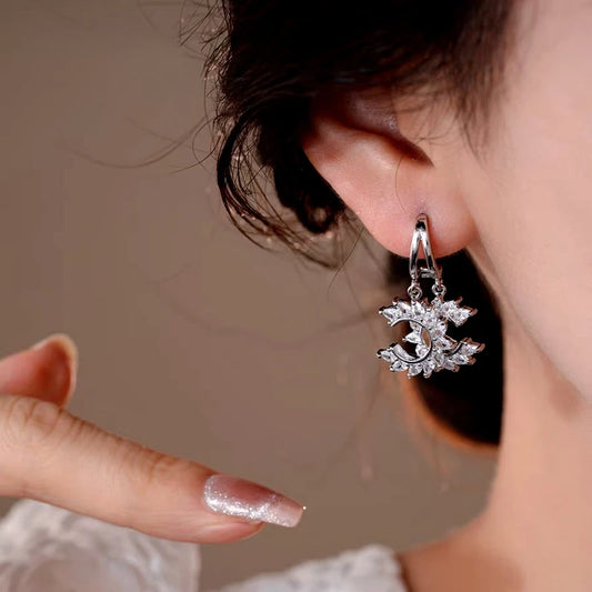 Model showcasing the dangle and style of the 14K Gold-Plated Elegant Zircon C-Shaped Earrings