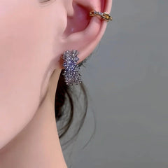 Model showcasing the dangle and style of the 14K Gold-Plated Elegant Zircon C-Shaped Earrings