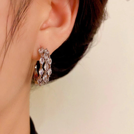 Model showcasing the dangle and style of the 14K Gold-Plated Elegant Zircon C-Shaped Earrings