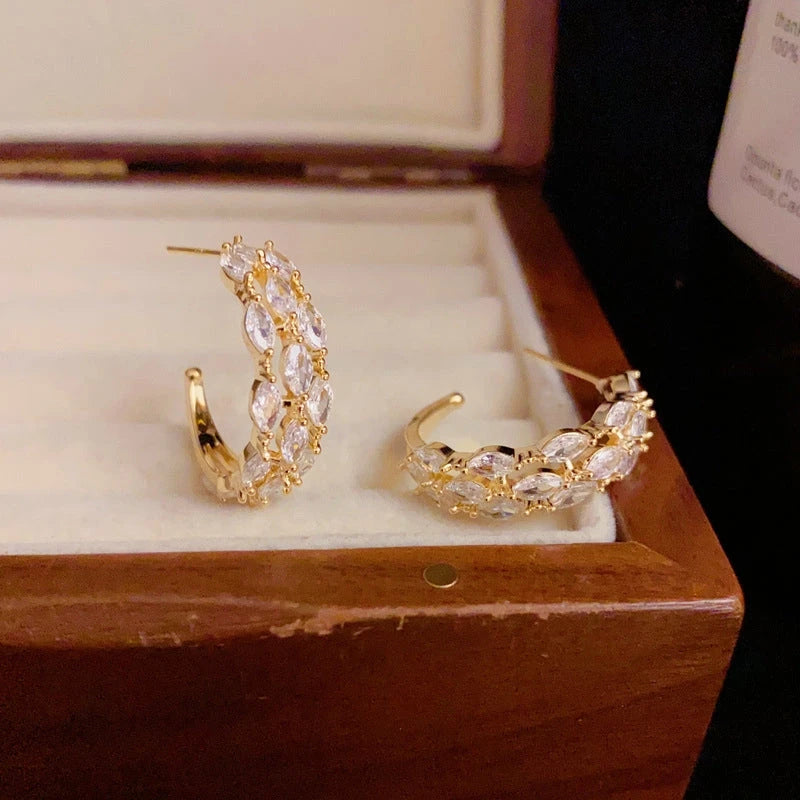 Close-up detail of the sparkling zircons and plating on the C-Shaped Dangle Earrings