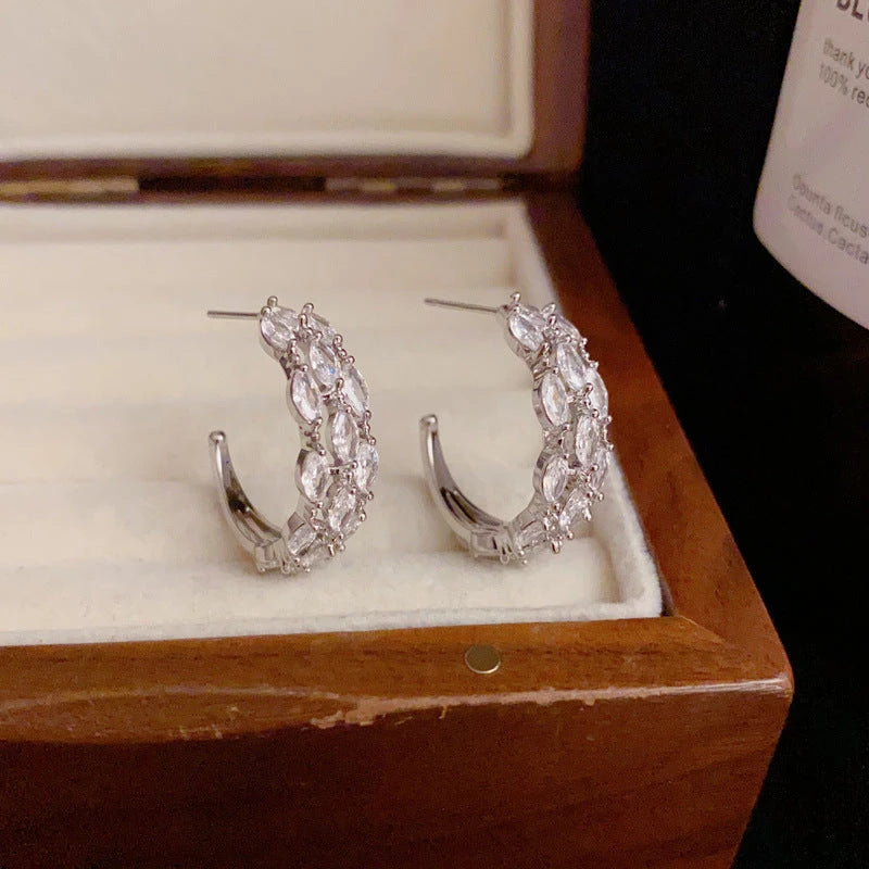 Angled view of the 14K Gold-Plated Elegant Zircon C-Shaped Earrings