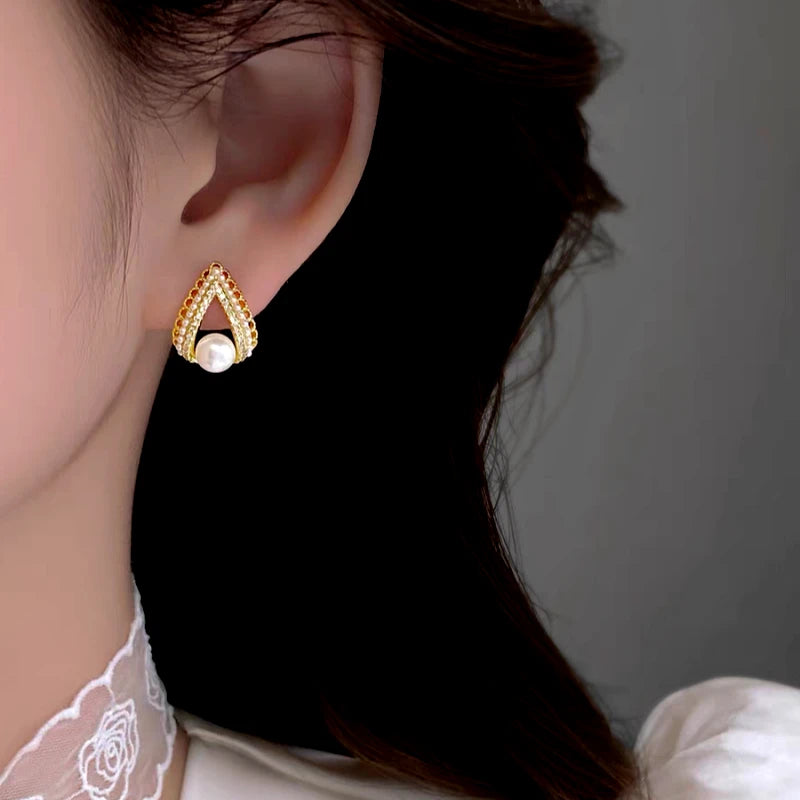 Angled view of the 14K Gold-Plated Elegant Zircon C-Shaped Pearl Earrings