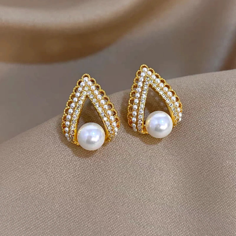 Model showcasing the dangle and style of the 14K Gold-Plated Elegant Zircon C-Shaped Pearl Earrings