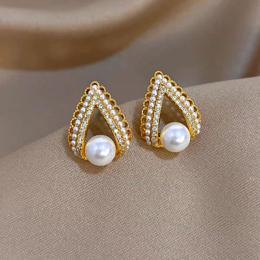 Model showcasing the dangle and style of the 14K Gold-Plated Elegant Zircon C-Shaped Pearl Earrings