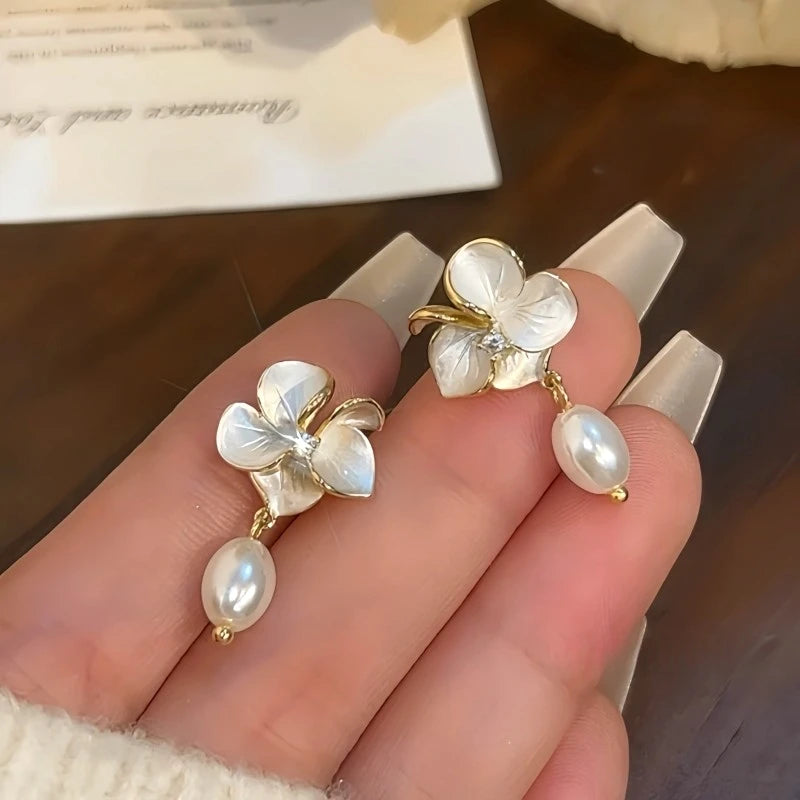 Model showcasing the dangle and style of the 14K Gold-Plated Elegant Zircon Camellia Bead Tassel Earrings