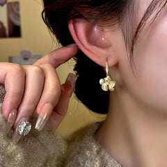 Model showcasing the dangle and style of the 14K Gold-Plated Elegant Zircon Camellia Ear Hook Earrings