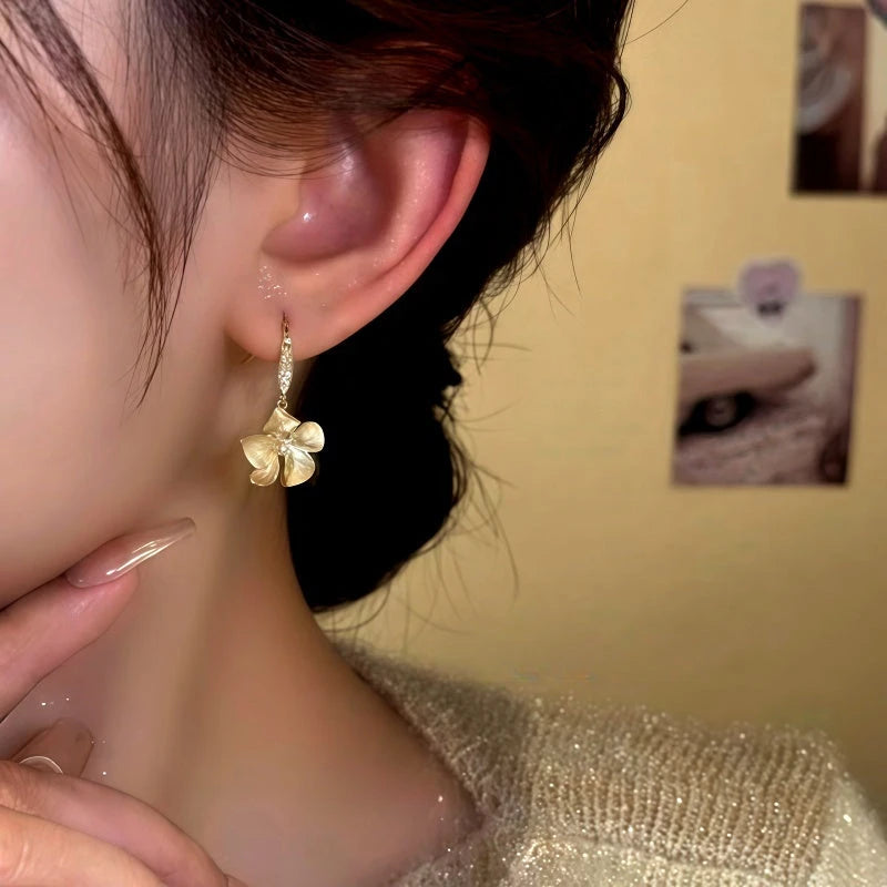 Close-up detail of the sparkling zircons and plating on the Camellia Ear Hooks