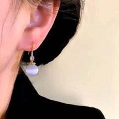 Close-up detail of the sparkling zircons and plating on the Cat's Eye Threader Earrings