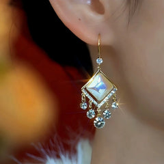 Model showcasing the dangle and style of the 14K Gold-Plated Elegant Zircon Cat's Eye Ear Hooks