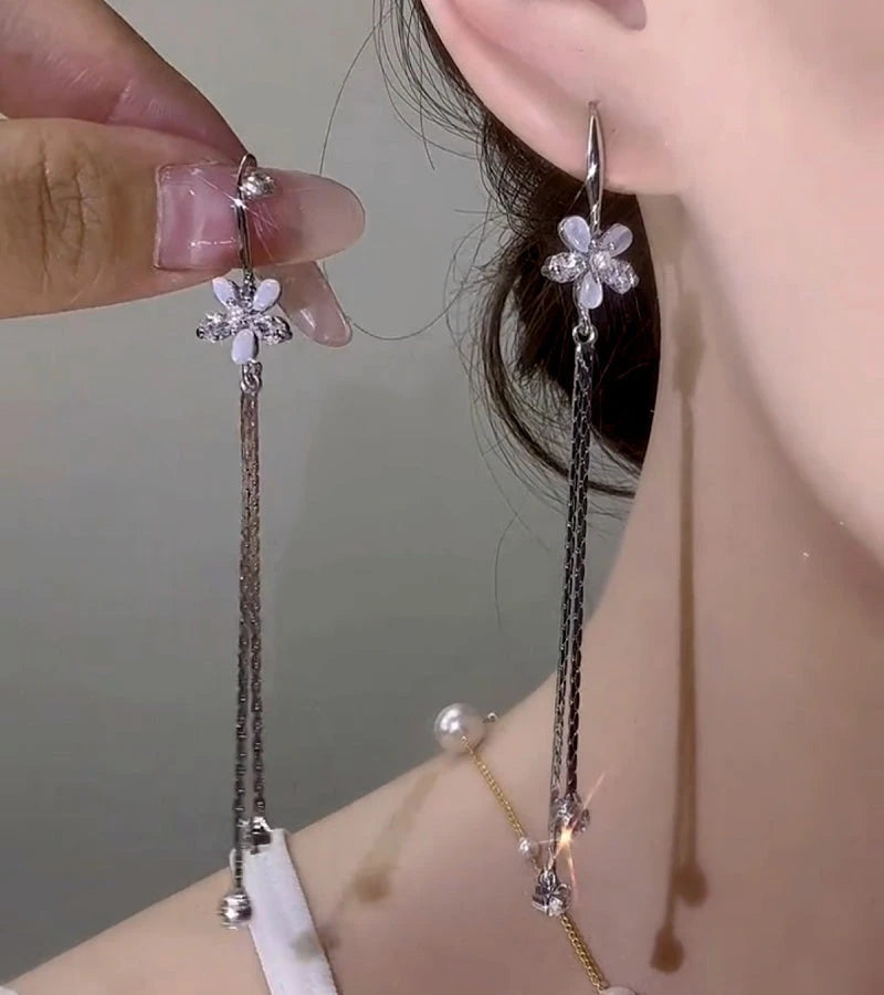 Model showcasing the dangle and style of the 14K Gold-Plated Elegant Zircon Cat's Eye Flower Ear Hook Earrings