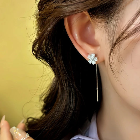Model showcasing the dangle and style of the 14K Gold-Plated Elegant Zircon Cat's Eye Flower Threader Earrings