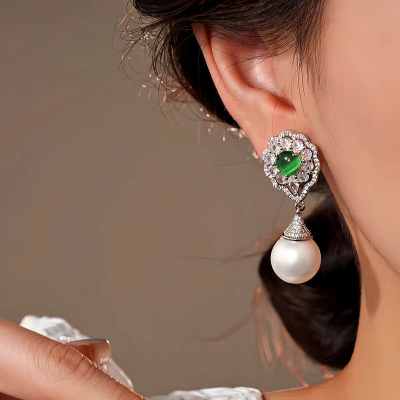 Model showcasing the dangle and style of the 14K Gold-Plated Elegant Zircon Cat's Eye Pearl Earrings