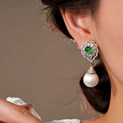 Model showcasing the dangle and style of the 14K Gold-Plated Elegant Zircon Cat's Eye Pearl Earrings