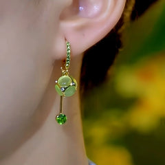 Close-up detail of the sparkling zircons and plating on the Cat's Eye Tassel Earrings