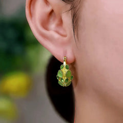 Model showcasing the dangle and style of the 14K Gold-Plated Elegant Zircon Cat's Eye Stone Basket Earrings