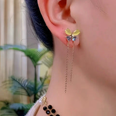 Model showcasing the dangle and style of the 14K Gold-Plated Elegant Zircon Cat's Eye Stone Butterfly Tassel Earrings