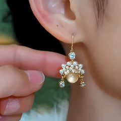 Model showcasing the dangle and style of the 14K Gold-Plated Elegant Zircon Cat's Eye Stone Ear Hooks
