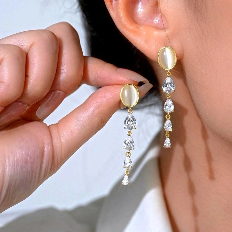Model showcasing the dangle and style of the 14K Gold-Plated Elegant Zircon Cat's Eye Stone Earrings