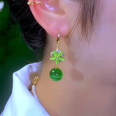 Model showcasing the dangle and style of the 14K Gold-Plated Elegant Zircon Cat's Eye Stone Flower And Bead Earrings