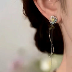 Model showcasing the dangle and style of the 14K Gold-Plated Elegant Zircon Cat's Eye Stone Flower Tassel Earrings