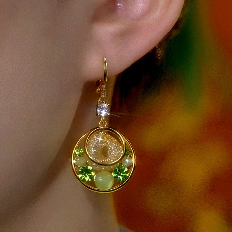 Model showcasing the dangle and style of the 14K Gold-Plated Elegant Zircon Cat's Eye Stone Hoop Earrings