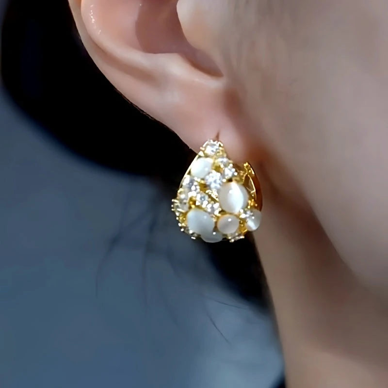 Model showcasing the dangle and style of the 14K Gold-Plated Elegant Zircon Cat's Eye Stone Water Drop Earrings