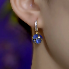 Model showcasing the dangle and style of the 14K Gold-Plated Elegant Zircon Cat's Eye Stone Water Drop Earrings