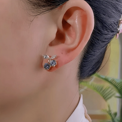 Model showcasing the dangle and style of the 14K Gold-Plated Elegant Zircon Cherry Stud Earrings