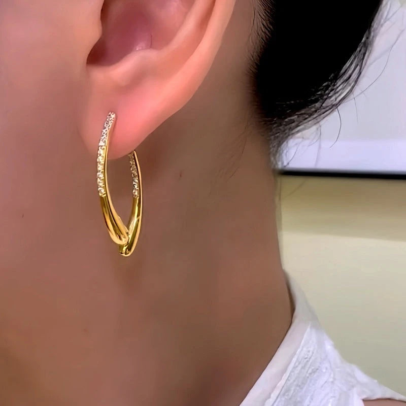 Model showcasing the dangle and style of the 14K Gold-Plated Elegant Zircon Cross Earrings