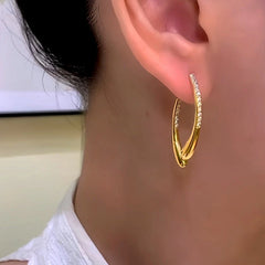 Close-up detail of the sparkling zircons and plating on the Cross Earrings