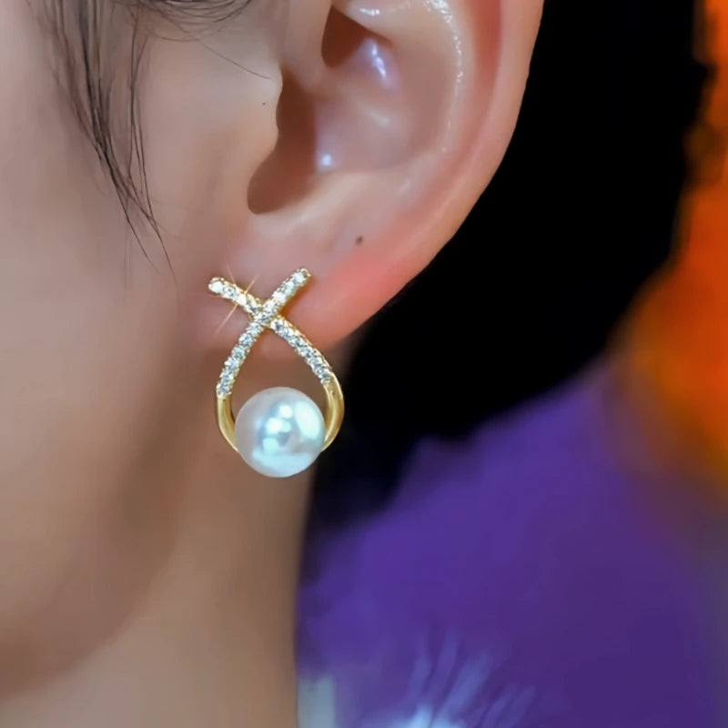 Close-up detail of the sparkling zircons and plating on the Cross Pearl Earrings