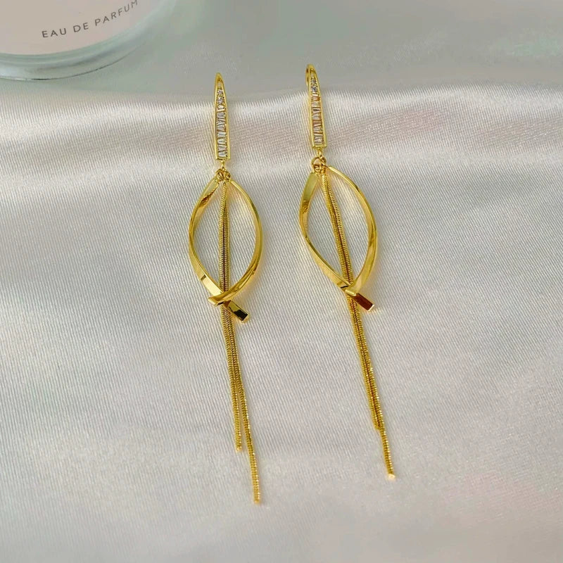 Angled view of the 14K Gold-Plated Elegant Zircon Cross Tassel Earrings