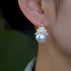 Model showcasing the dangle and style of the 14K Gold-Plated Elegant Zircon Crown Imitation Pearl Earrings