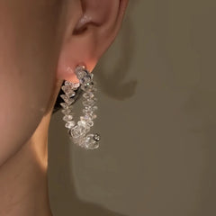 Close-up detail of the sparkling zircons and plating on the Crystal Cross Earrings