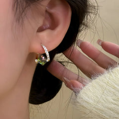 Model showcasing the dangle and style of the 14K Gold-Plated Elegant Zircon Crystal Earrings