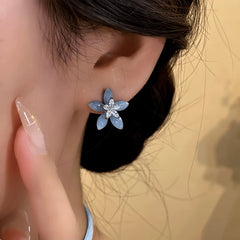 Model showcasing the dangle and style of the 14K Gold-Plated Elegant Zircon Crystal Flower Stud Earrings