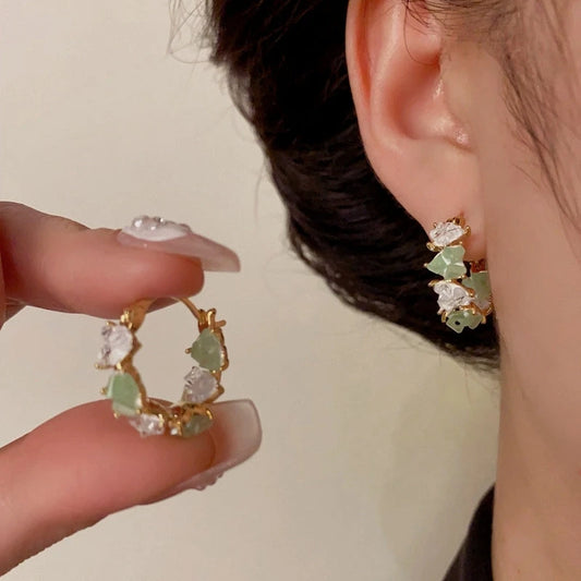 Model showcasing the dangle and style of the 14K Gold-Plated Elegant Zircon Crystal Heart Hoop Earrings