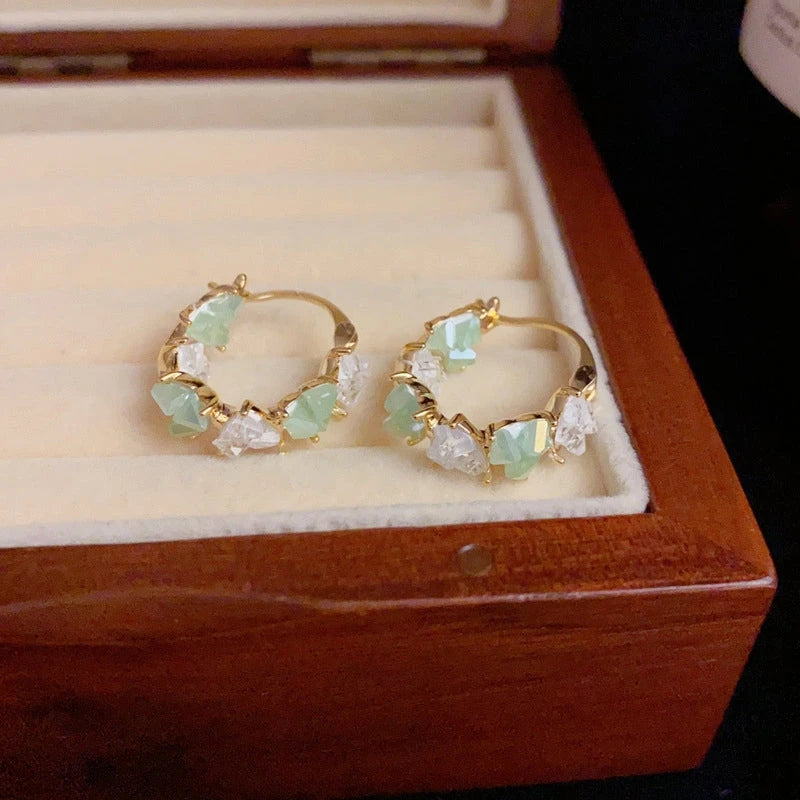 Angled view of the 14K Gold-Plated Elegant Zircon Crystal Heart Hoop Earrings