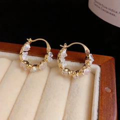 Close-up detail of the sparkling zircons and plating on the Heart Hoop Earrings